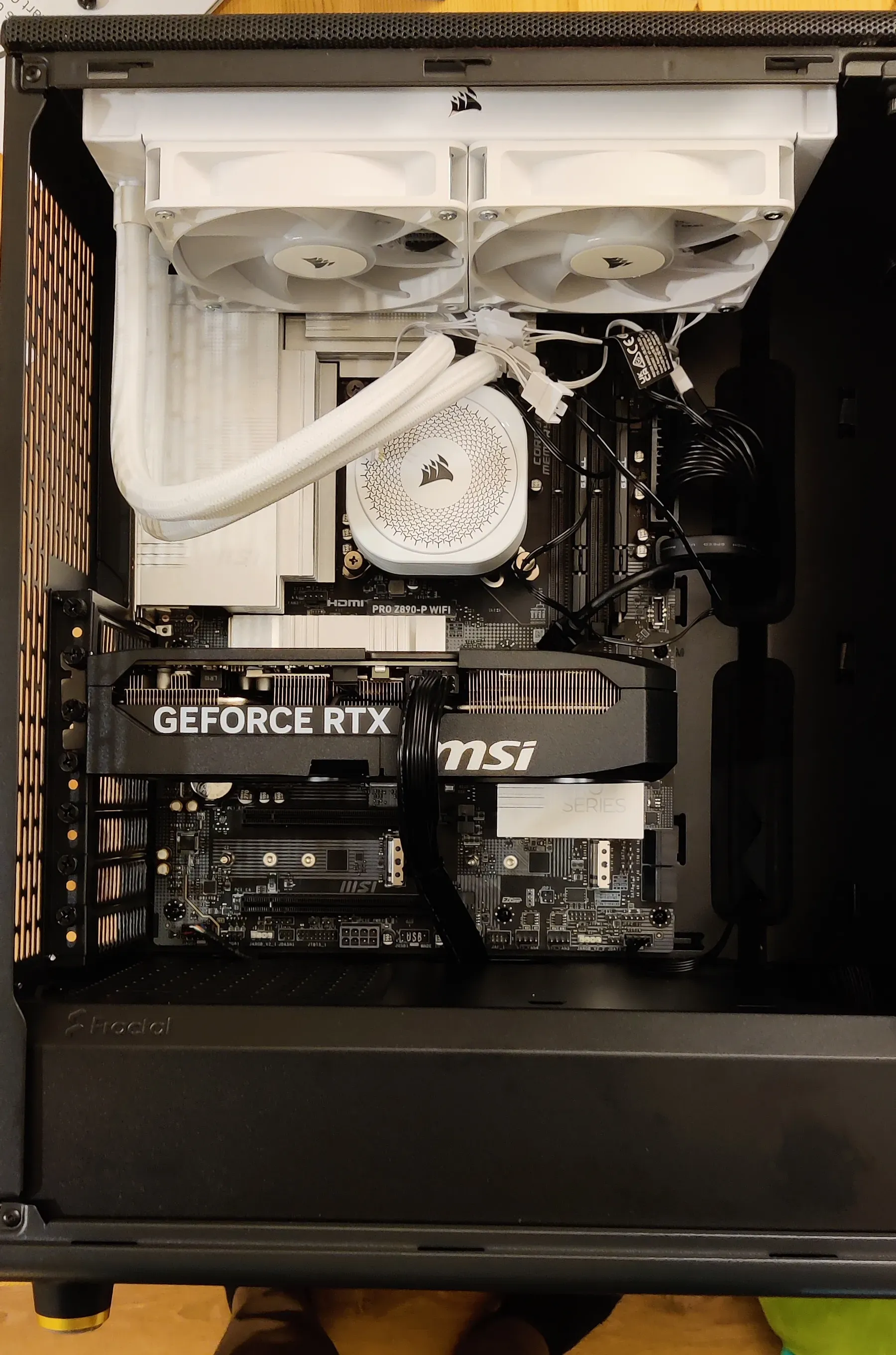 Computer internals: motherboard, AIO, GPU, and fans, fully assembled in a case