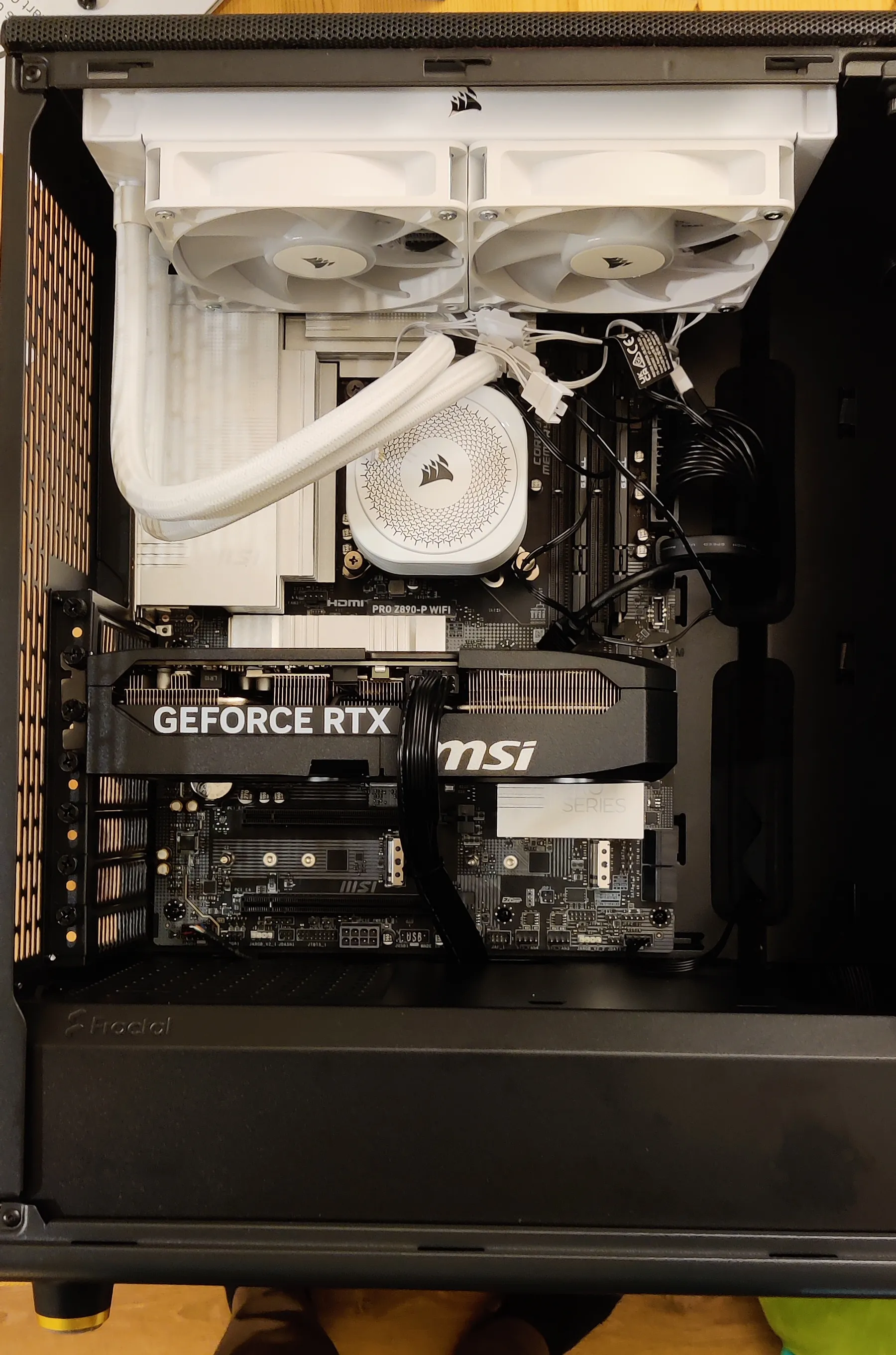 Computer internals: motherboard, AIO, GPU, and fans, fully assembled in a case