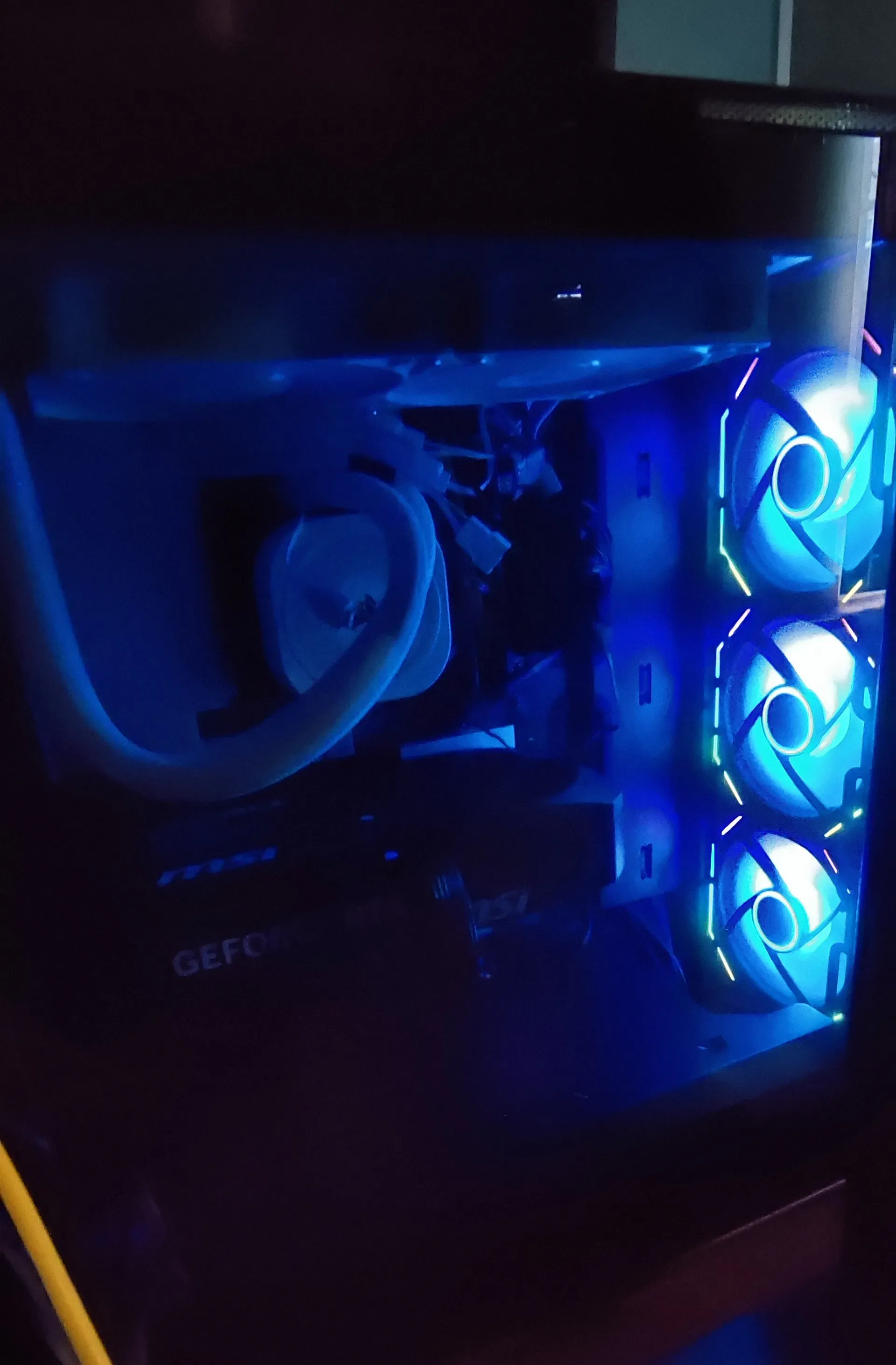 Photo of computer internals through case glass, in the dark, with RGB lights