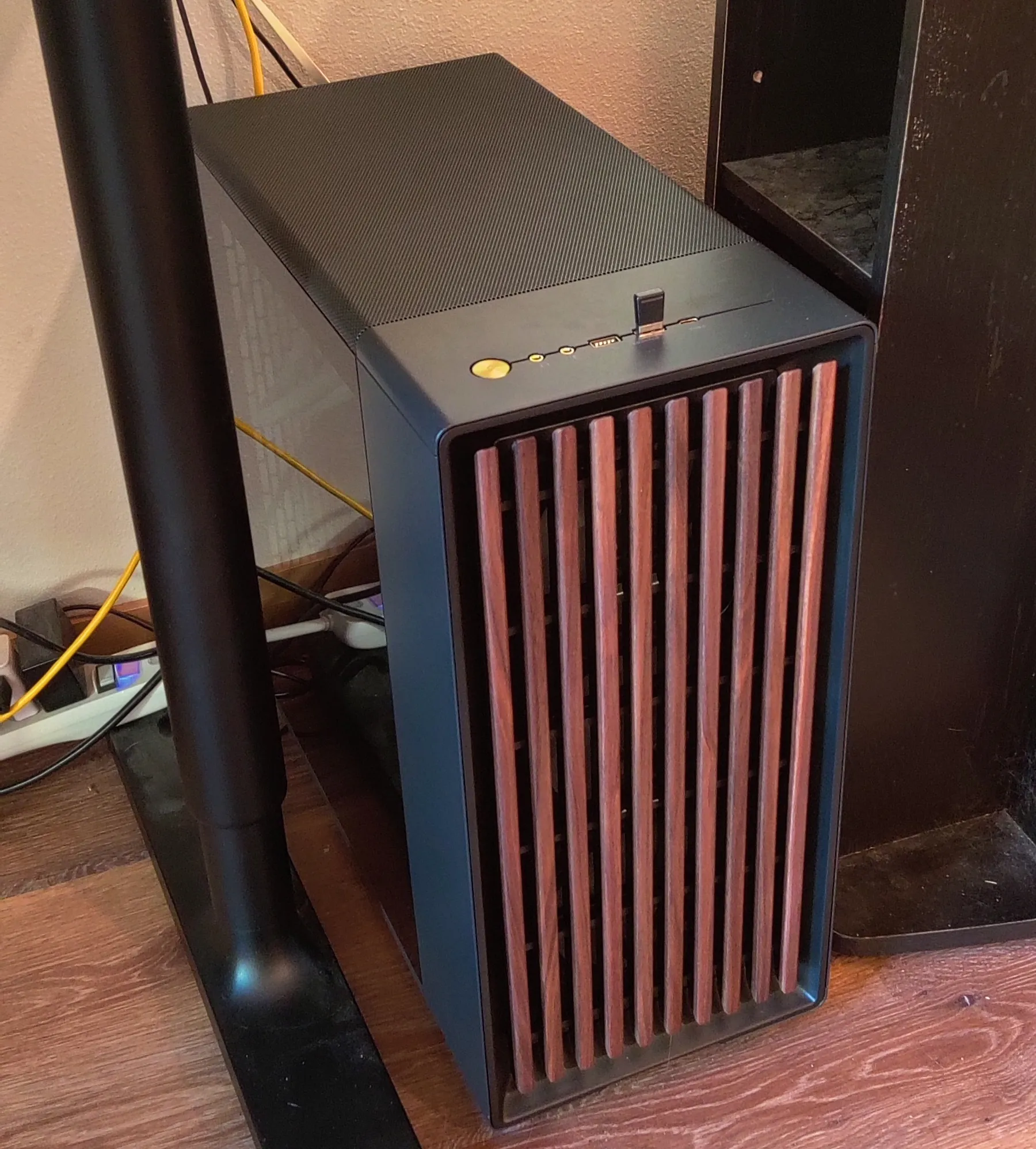 Desktop computer in a lit room with vertical wooden slats and no RGB