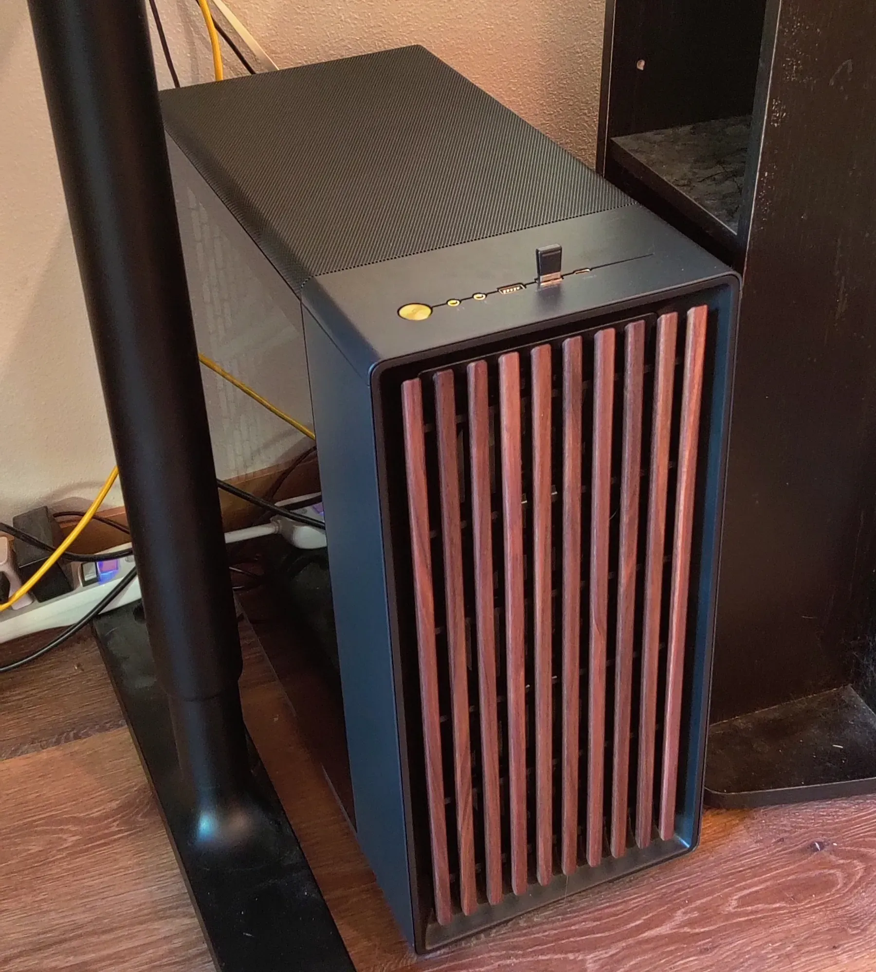 Desktop computer in a lit room with vertical wooden slats and no RGB